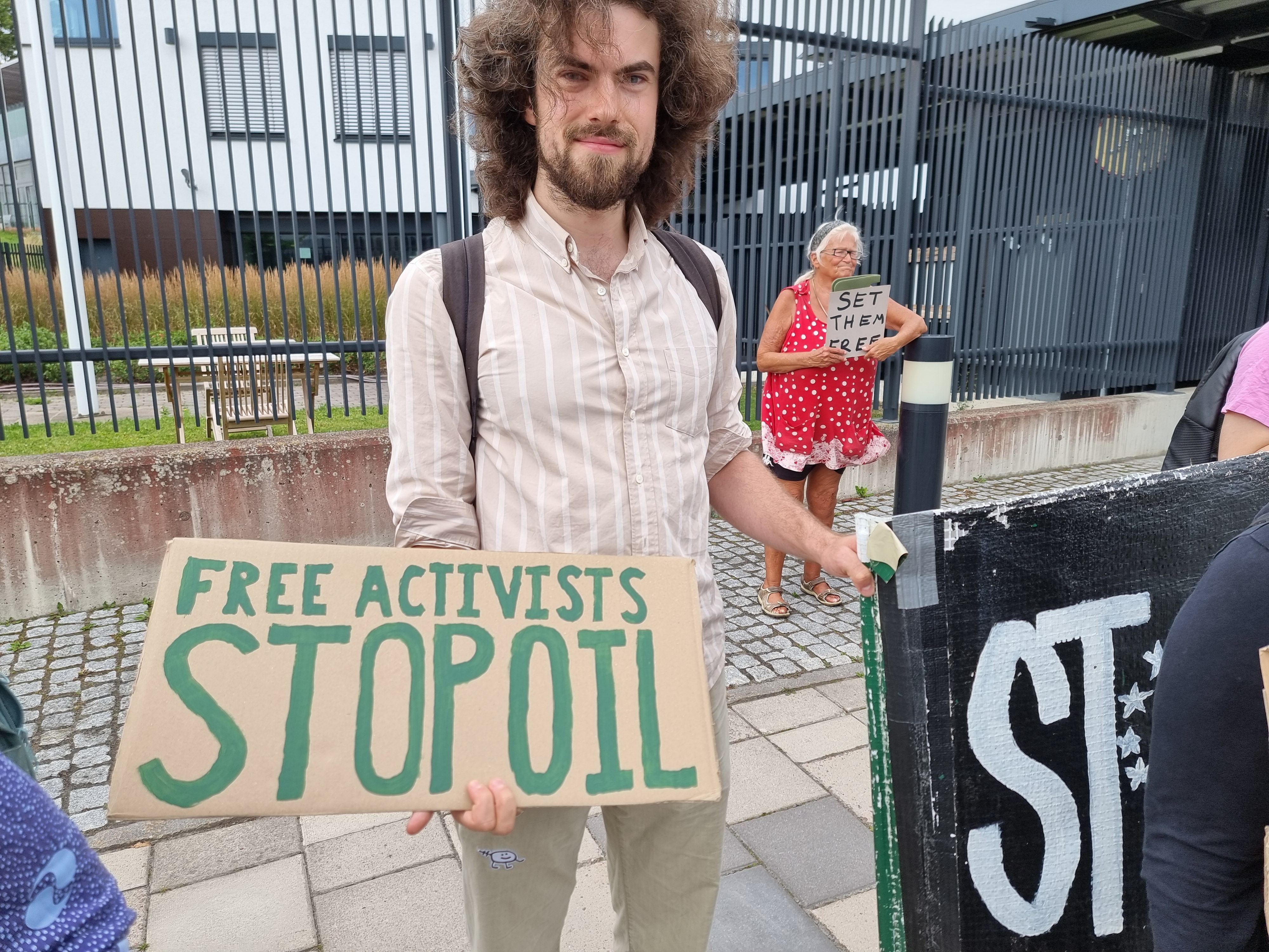 Ludvig protesting outside the British Embassy with the text “Free the activists! Stop the oil!”